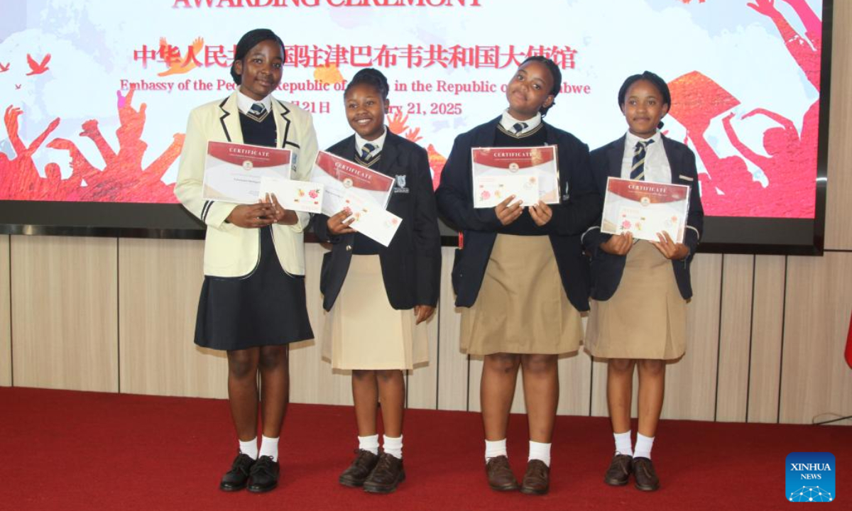 Awardees show their certificates during the China-Zimbabwe Friendship Scholarship awarding ceremony at the Chinese embassy in Harare, Zimbabwe, on Jan. 21, 2025. A total of 52 Chinese language learners in Zimbabwe on Tuesday received scholarships under the China-Zimbabwe Friendship Scholarship program for academic excellence. (Xinhua/Tafara Mugwara)