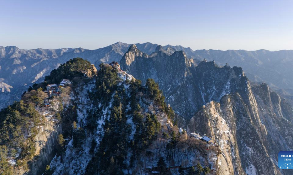This aerial drone photo taken on Feb. 3, 2025 shows the scenery of Huashan Mountain in Weinan City, northwest China's Shaanxi Province. Huashan Mountain ushered in peak tourist season during the Spring Festival holiday with the average number of daily visitors exceeding 20,000. (Xinhua/Zou Jingyi)
