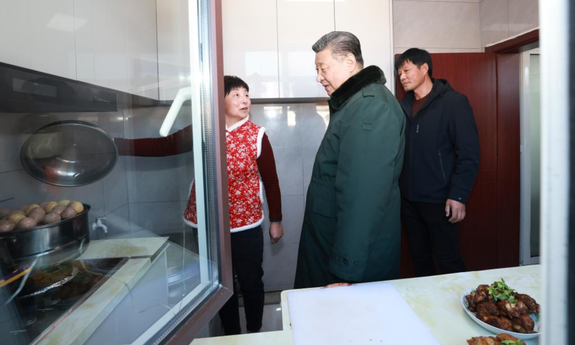 Chinese President Xi Jinping, also general secretary of the Communist Party of China Central Committee and chairman of the Central Military Commission, visits the villagers who have moved into their new houses and inquires about the quality of the reconstructed homes and whether their daily living conditions are adequate, in Zhujiagou Village, Suizhong County of Huludao City, northeast China's Liaoning Province, Jan. 22, 2025. Xi braved the cold to visit people affected by floods in the village in northeast China's Liaoning Province. (Xinhua/Wang Ye)