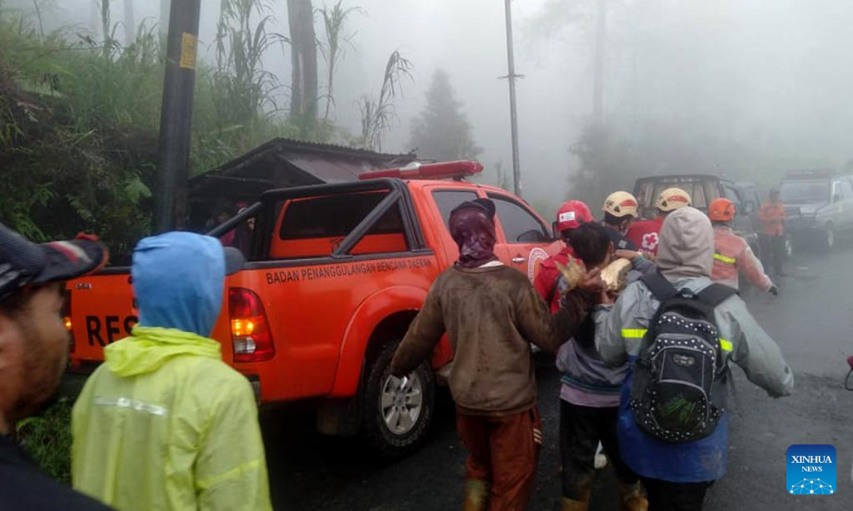 This mobile phone photo provided by Indonesia's National Disaster Management Agency (BNPB) shows rescue teams evacuating a body of a victim after landslide hit Kasimpar village in Pekalongan Regency, Central Java, Indonesia, Jan. 21, 2025. The death toll from landslides that struck Pekalongan region in Indonesia's Central Java province on Tuesday has risen to 18, according to the provincial disaster mitigation agency. (BNPB/Handout via Xinhua)