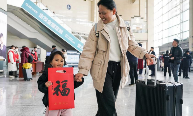 Travelers walk in Hefei Railway Station in Hefei, east China's Anhui Province, Jan. 14, 2025. The Spring Festival, China's biggest traditional holiday, will fall on Jan. 29 this year. The Spring Festival travel rush, or chunyun, the world's largest annual human migration known for its high transportation demand as millions return home for family reunions, kicked off on Tuesday. (Xinhua/Du Yu)