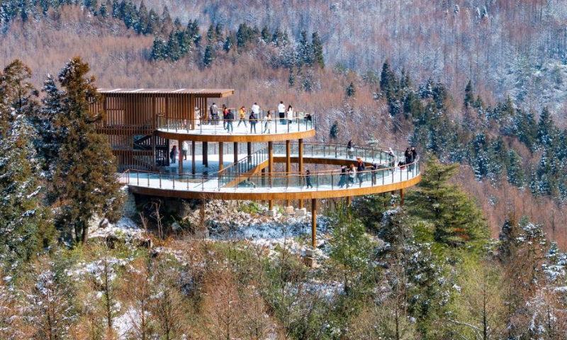 An aerial drone photo taken on Jan. 11, 2025 shows tourists enjoying the snow scenery at the Shanwangping Karst national ecological park, in Nanchuan District of southwest China's Chongqing. (Photo by Luo Chuan/Xinhua)