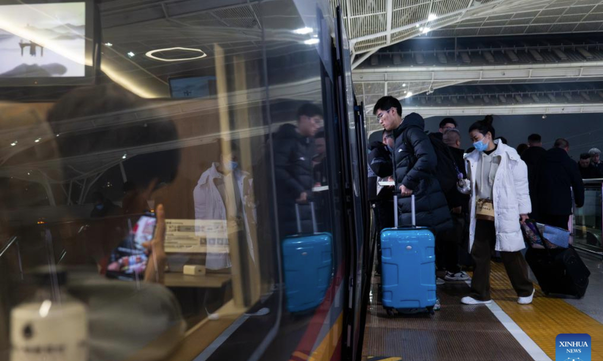 Passengers board a train at Wuhan Railway Station in Wuhan, central China's Hubei Province, Jan. 20, 2025. As this year's Spring Festival travel rush began on Jan. 14, China Railway Wuhan Bureau Group Co., Ltd. has scheduled to add 47 overnight high-speed trains daily towards major cities from Jan. 20 to 27, in an effort to better cater for passengers. (Xinhua/Wu Zhizun)