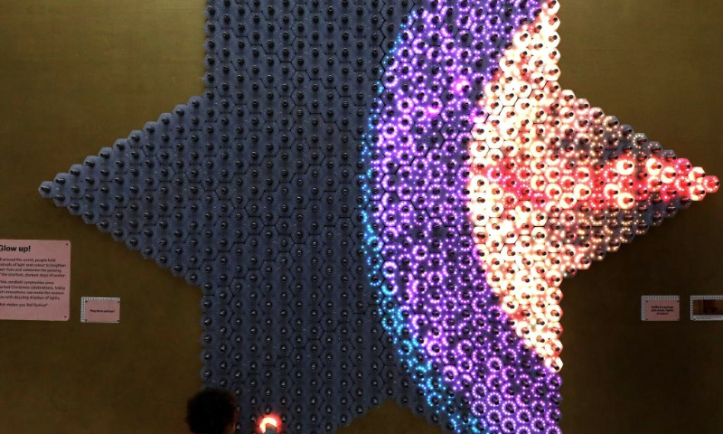 A child plays with an art installation named Quantum Jungle at Young V&A in London, Britain, Jan. 14, 2025. Quantum Jungle, an interactive light installation, features a mass of touch-sensitive tactile springs and LEDs. (Xinhua/Li Ying)