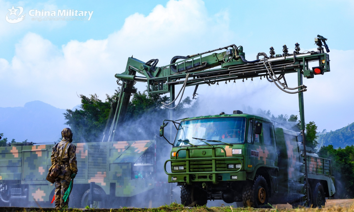 A military vehicle attached to a chemical defense element of a brigade under the Chinese PLA 73rd Group Army is decontaminated by a pressure washing system during an emergency drill on January 2, 2025. (eng.chinamil.com.cn/Photo by Yang Qi)