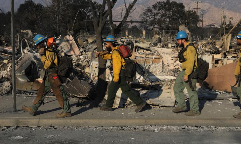 Firefighters work in the wildfire-ravaged area of Altadena, Los Angeles County, California, the United States, on Jan. 10, 2025. Devastating wildfires continue to rage across different parts of Los Angeles County on Friday, leading to widespread disruptions, including school closures and the cancellation of entertainment, sports, and community events.

As of Friday, the wildfires have destroyed more than 12,300 structures and claimed at least 11 lives, with officials warning the true death toll will remain unclear until it is safe for investigators to go into neighborhoods. More than 100,000 people are under evacuation orders, with tens of thousands more under warnings. (Photo by Qiu Chen/Xinhua)