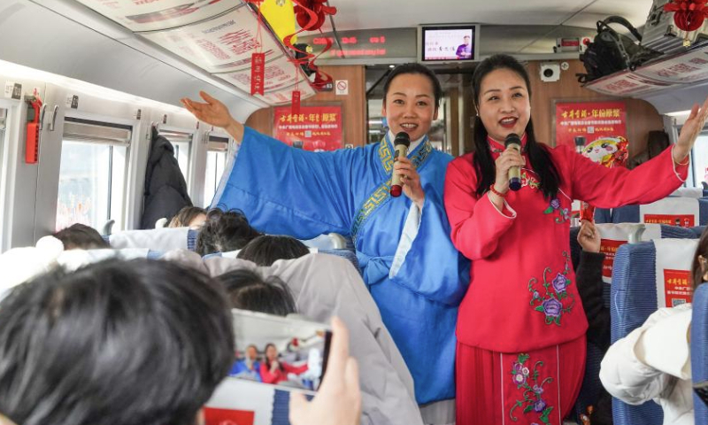 Staff members dressed in costumes perform Huangmei Opera, a national-level intangible cultural heritage in China, on train C3685, east China's Anhui Province, Jan. 13, 2025. The Hefei branch of China Railway Shanghai Bureau Group Co., Ltd. organized railway staff to demonstrate local intangible cultural heritages on the train, adding festive atmosphere to the upcoming Spring Festival travel rush. (Xinhua/Du Yu)