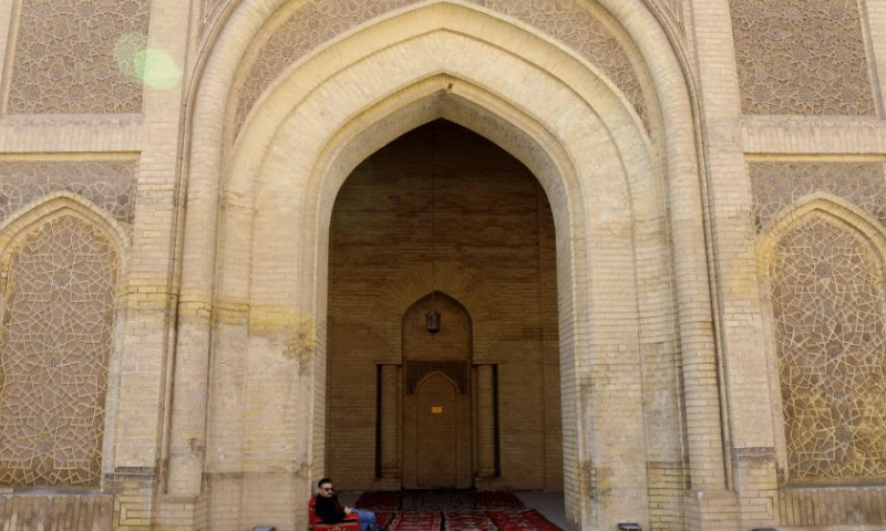 A visitor sits inside a building of Mustansiriya Madrasah in Baghdad, Iraq, Jan. 15, 2025. The historical building established in 1227 was once a scholarly complex providing higher education. (Xinhua/Khalil Dawood)