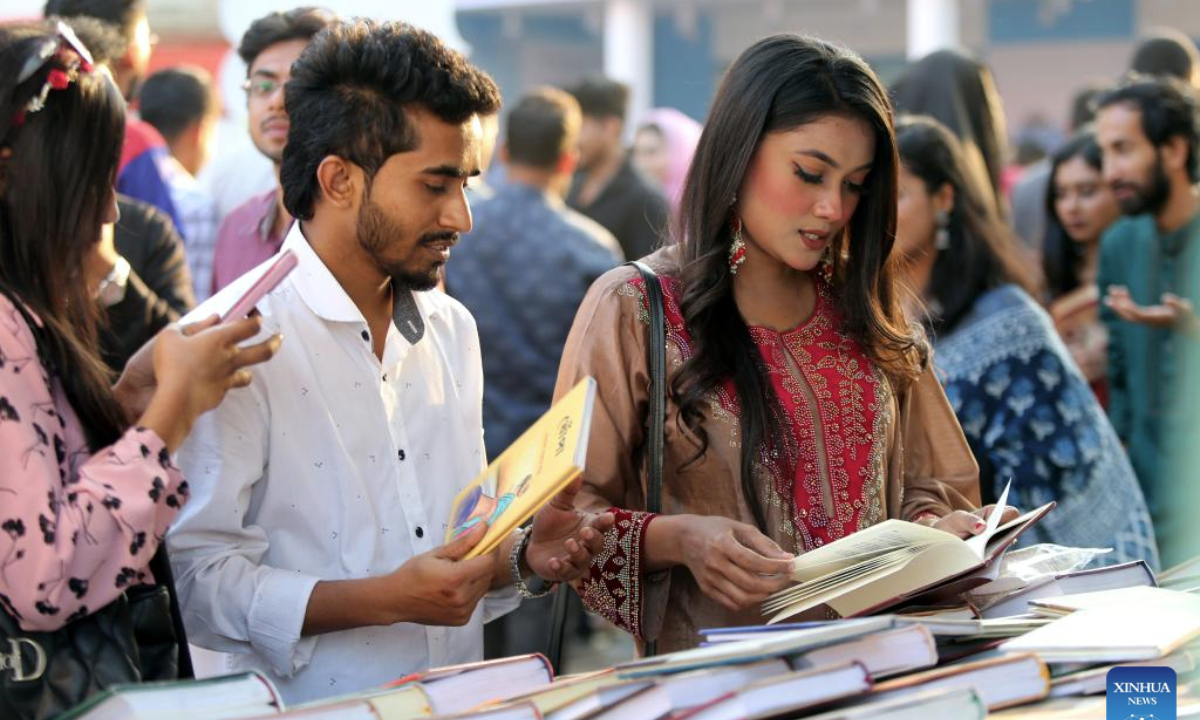 People browse books at a stall during the Amar Ekushey Book Fair in Dhaka, Bangladesh, Feb. 7, 2025. The month-long annual book fair kicked off in the capital Dhaka on Feb. 1, 2025. About 700 publishers have participated in the fair. (Photo by Habibur Rahman/Xinhua)