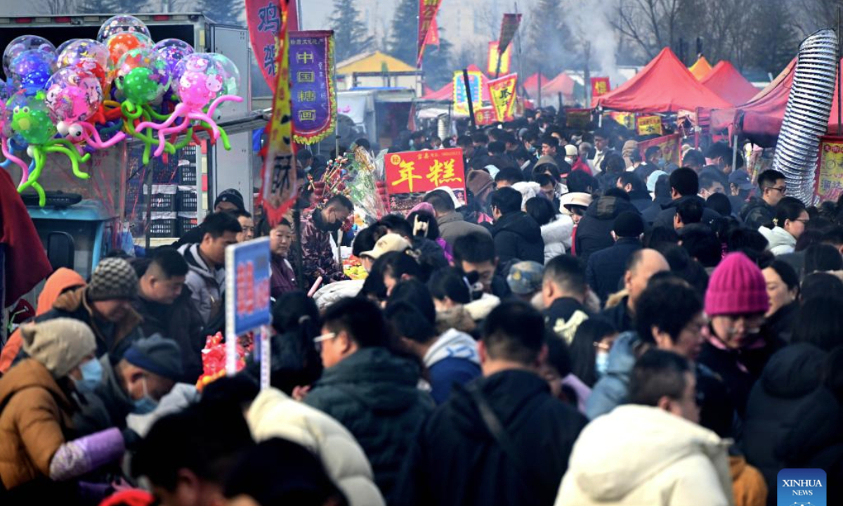 People select products at the Poli Market in Qingdao Xihai'an (West Coast) New Area in Qingdao, east China's Shandong Province, Jan. 18, 2025. With a history of more than 300 years, the Poli Market is a local intangible cultural heritage and one of the biggest traditional markets in eastern Shandong Province. As the Spring Festival approaches, many visitors flock to the market for abundant new year decorations, agricultural products, local delicacies and so on. (Xinhua/Li Ziheng)