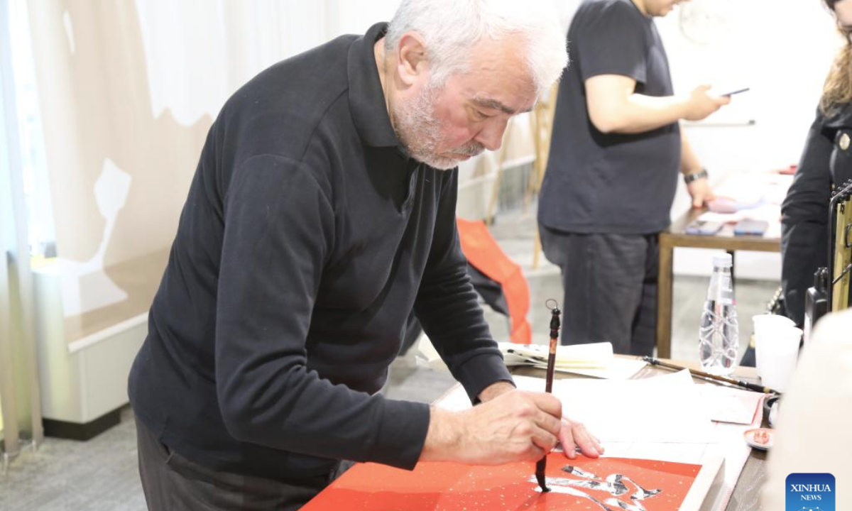 A Bulgarian man writes Chinese calligraphy during a celebration dedicated to the upcoming Spring Festival in Sofia, Bulgaria, Jan. 12, 2025. (Photo by Marian Draganov/Xinhua)