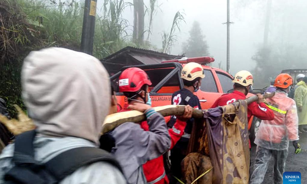 This mobile phone photo provided by Indonesia's National Disaster Management Agency (BNPB) shows rescue teams evacuating a body of a victim after landslide hit Kasimpar village in Pekalongan Regency, Central Java, Indonesia, Jan. 21, 2025. The death toll from landslides that struck Pekalongan region in Indonesia's Central Java province on Tuesday has risen to 18, according to the provincial disaster mitigation agency. (BNPB/Handout via Xinhua)
