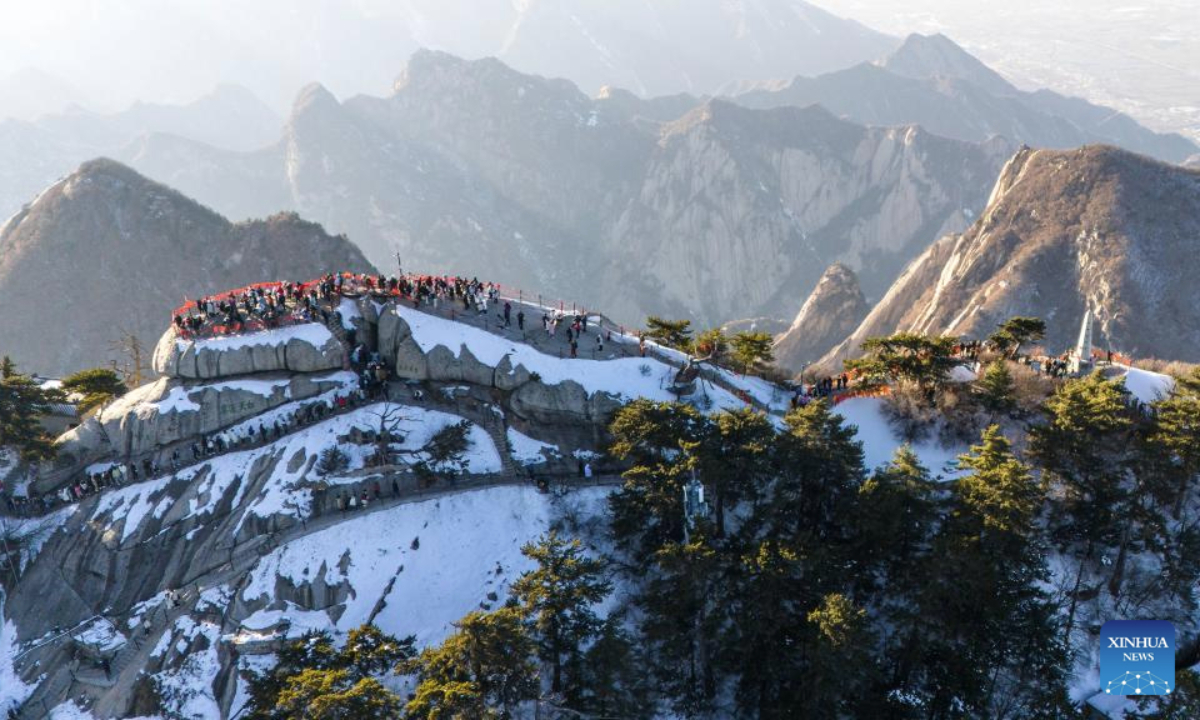 This aerial drone photo taken on Feb. 3, 2025 shows the scenery of Huashan Mountain in Weinan City, northwest China's Shaanxi Province. Huashan Mountain ushered in peak tourist season during the Spring Festival holiday with the average number of daily visitors exceeding 20,000. (Xinhua/Zou Jingyi)