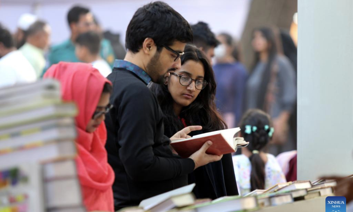People browse books at a stall during the Amar Ekushey Book Fair in Dhaka, Bangladesh, Feb. 7, 2025. The month-long annual book fair kicked off in the capital Dhaka on Feb. 1, 2025. About 700 publishers have participated in the fair. (Photo by Habibur Rahman/Xinhua)