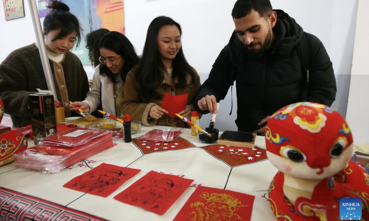 Young people from China and Algeria create New Year paintings at Algiers 2 University in Algeria, Jan. 20, 2025. The Algiers 2 University celebrated the Chinese New Year on Monday with a vibrant event, featuring a range of cultural displays on campus that showcased Chinese traditional paintings, calligraphy, paper cutting, and clothing. (Xinhua)