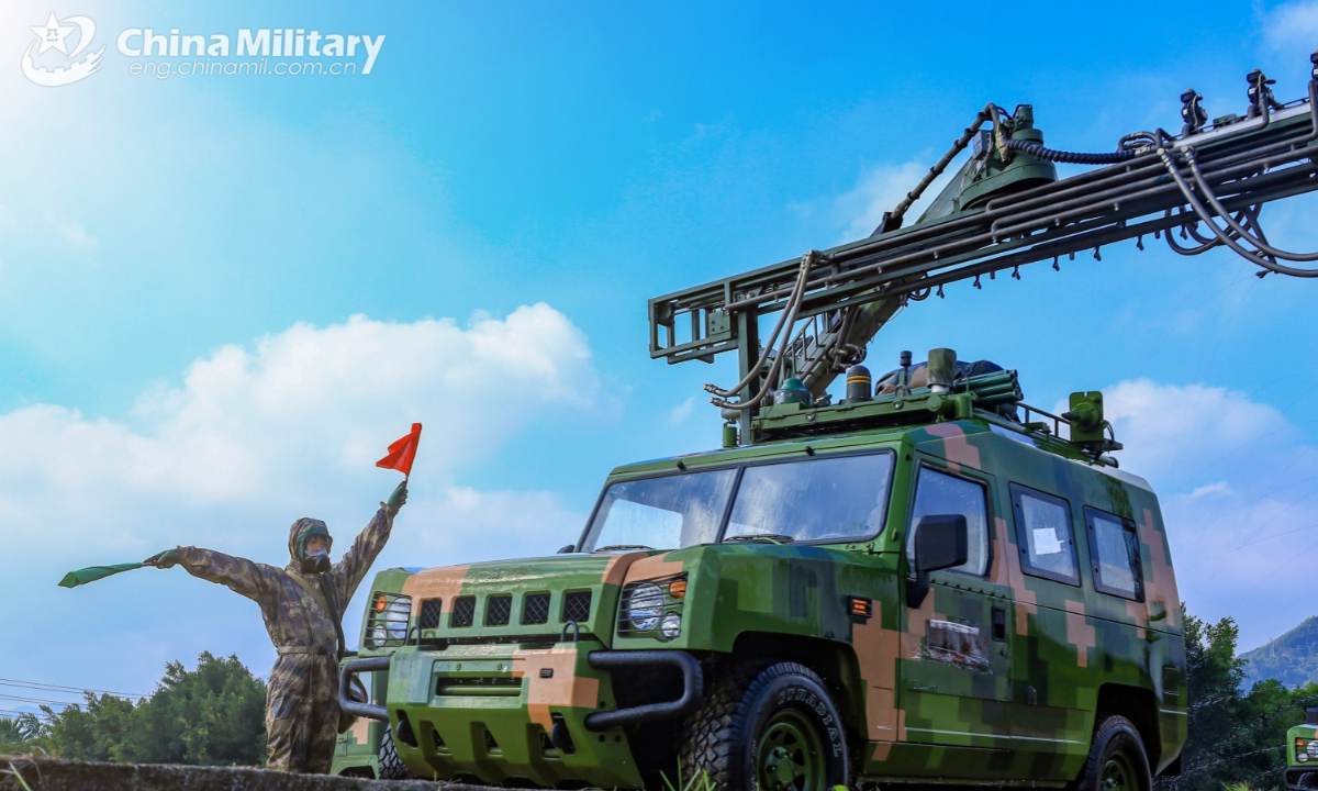 A soldier assigned to a chemical defense element of a brigade under the Chinese PLA 73rd Group Army directs a military vehicle to the position for Chemical, Biological, Radioactive and Nuclear (CBRN) decontamination during an emergency drill on January 2, 2025. (eng.chinamil.com.cn/Photo by Yang Qi)
