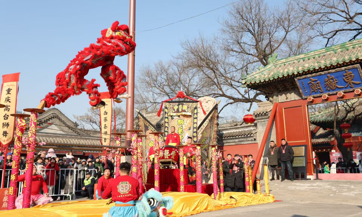 People watch a lion dance performance during a temple fair at the Dongyue temple in Beijing on January 29, 2025. Photo: VCG