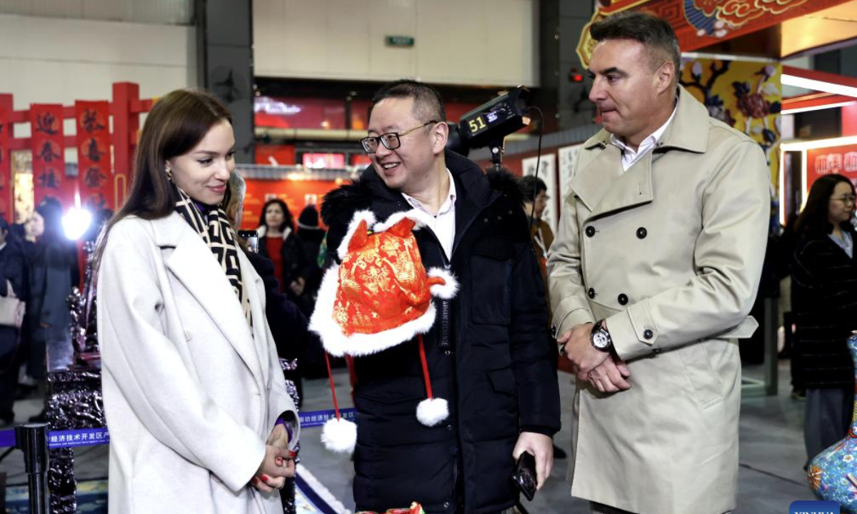 Members of the diplomatic corps know about a tiger hat at a festive event for the upcoming Chinese New Year, or the Spring Festival, in Langfang, north China's Hebei Province, Jan. 23, 2025. (Xinhua/Wang Xiao)