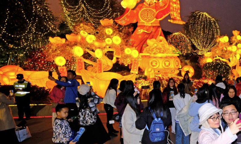 People take photos before light installations in Nanning, capital of south China's Guangxi Zhuang Autonomous Region, Jan. 18, 2025. Lanterns and light installations have been arranged across China for the upcoming Spring Festival, or the Chinese Lunar New Year, which falls on Jan. 29 this year. (Xinhua/Zhou Hua)