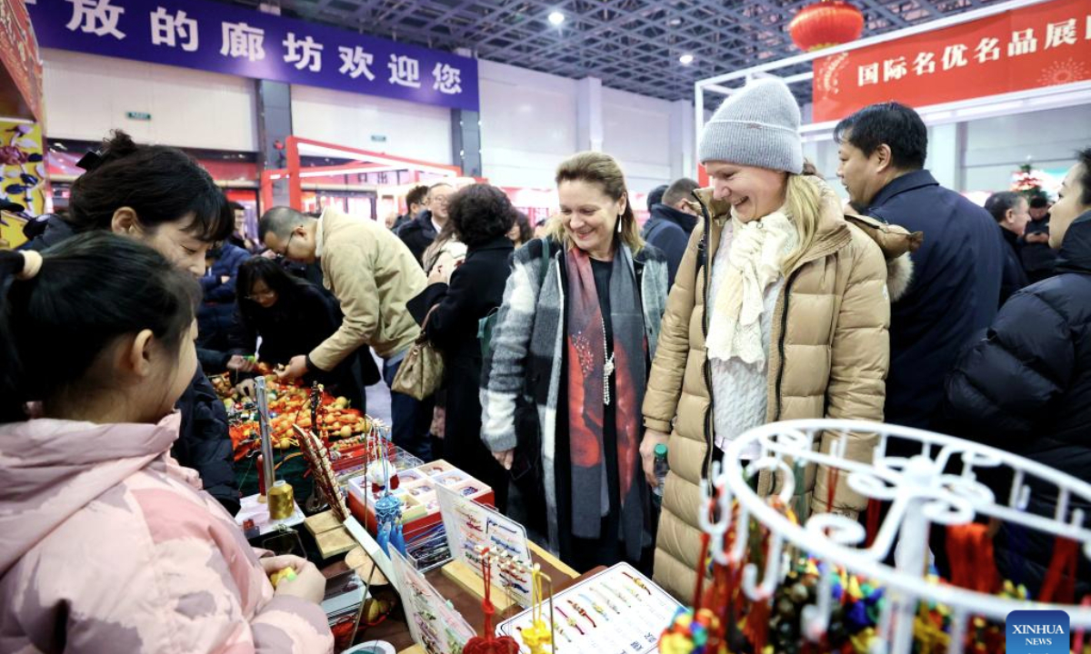 Members of the diplomatic corps select products at a festive event for the upcoming Chinese New Year, or the Spring Festival, in Langfang, north China's Hebei Province, Jan. 23, 2025. (Xinhua/Wang Xiao)