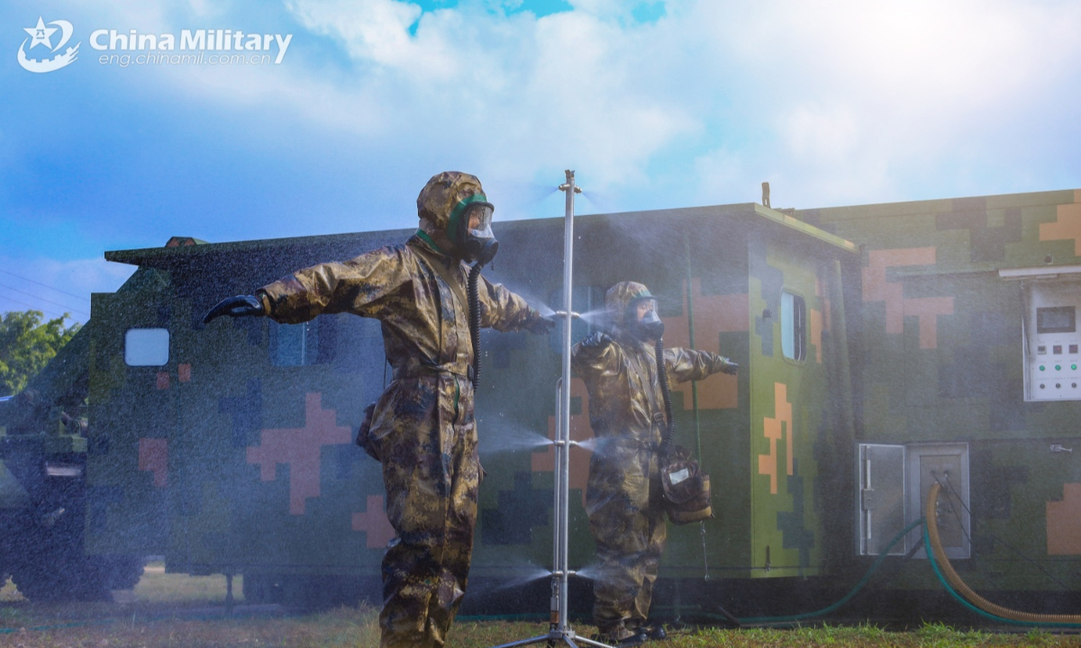 Soldiers assigned to a chemical defense element of a brigade under the Chinese PLA 73rd Group Army use a portable decontamination shower to conduct Chemical, Biological, Radioactive and Nuclear (CBRN) decontamination during an emergency drill on January 2, 2025. (eng.chinamil.com.cn/Photo by Yang Qi)