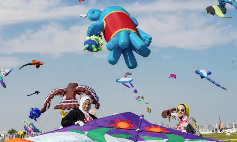 Participants prepare to fly a kite during the Qatar Kite Festival 2025 at Old Doha Port in Doha, Qatar, Jan. 19, 2025. (Photo by Nikku/Xinhua)
