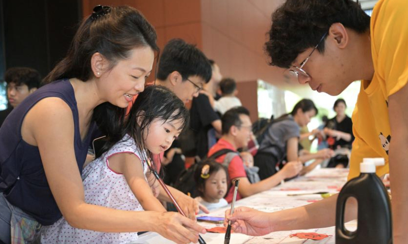 People participate in an activity celebrating Chinese New Year at Singapore Chinese Cultural Centre, Singapore, on Jan. 19, 2025. Celebrations and cultural activities are being held around the globe to welcome the upcoming Chinese New Year. (Photo by Then Chih Wey/Xinhua)