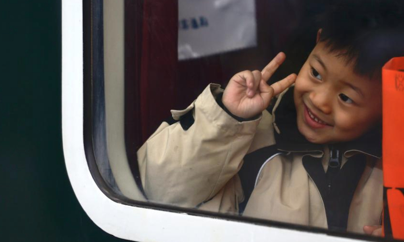 A boy gestures aboard train T258 from Urumqi, northwest China's Xinjiang Uygur Autonomous Region, to Lanzhou, northwest China's Gansu Province, Jan. 14, 2025. The Spring Festival, China's biggest traditional holiday, will fall on Jan. 29 this year. The Spring Festival travel rush, or chunyun, the world's largest annual human migration known for its high transportation demand as millions return home for family reunions, kicked off on Tuesday. (Xinhua/Chen Shuo)