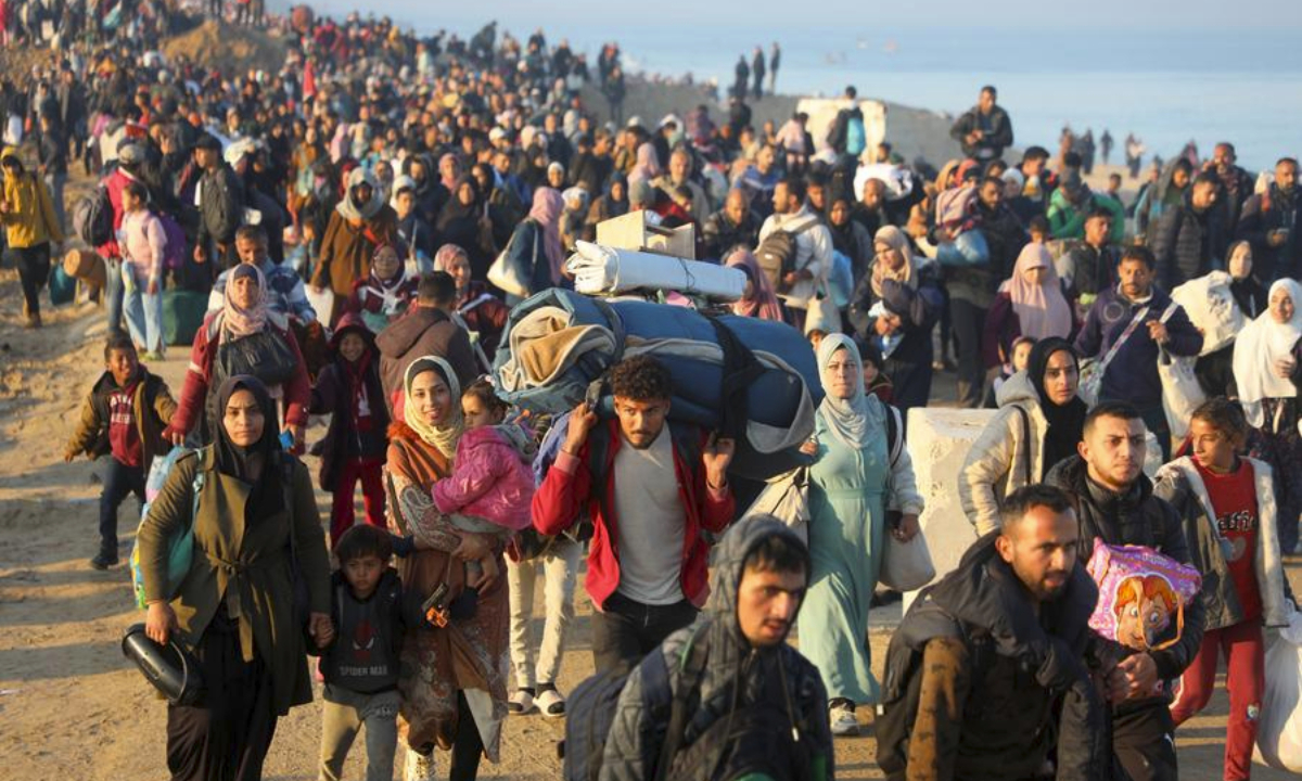 Displaced people are seen on their way home to the north of the Gaza Strip, near al-Nuseirat refugee camp in central Gaza Strip, on Jan. 27, 2025.  (Photo by Rizek Abdeljawad/Xinhua)