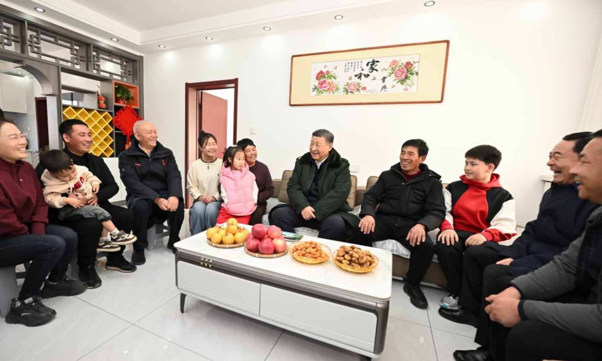 Chinese President Xi Jinping, also general secretary of the Communist Party of China Central Committee and chairman of the Central Military Commission, visits the villagers who have moved into their new houses and inquires about the quality of the reconstructed homes and whether their daily living conditions are adequate, in Zhujiagou Village, Suizhong County of Huludao City, northeast China's Liaoning Province, Jan. 22, 2025. Xi braved the cold to visit people affected by floods in the village in northeast China's Liaoning Province. (Xinhua/Xie Huanchi)