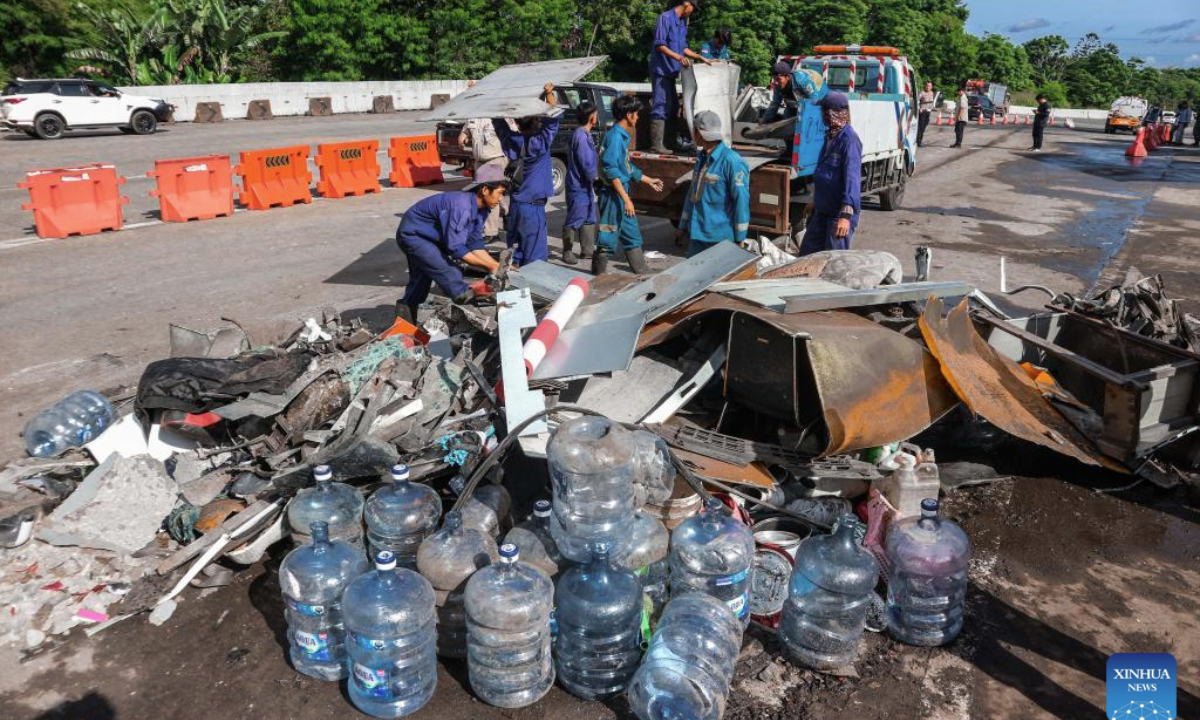 People collect the wreckage at the site of a traffic accident near the Ciawi Toll Gate in Bogor Regency, Indonesia, Feb. 5, 2025. Eight people were killed and 11 others were injured in a traffic accident in Indonesia's West Java province on Tuesday night, a senior official confirmed on Wednesday morning. (Photo by Rangga Firmansyah/Xinhua)