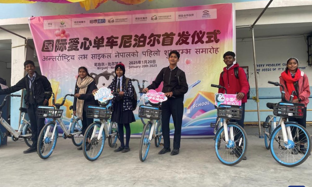 Students pose for a photo with bicycles donated under an international bicycle project initiated by the China Foundation for Rural Development in collaboration with Hello Inc. in Birgunj, Madhesh Province, Nepal, Jan. 20, 2025. (Nepal Office of the China Foundation for Rural Development/Handout via Xinhua)