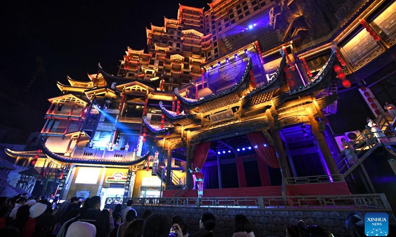 Tourists watch stage performance at a scenic spot noted for a splendid building in Zhangjiajie, central China's Hunan Province, on Jan. 9, 2025.