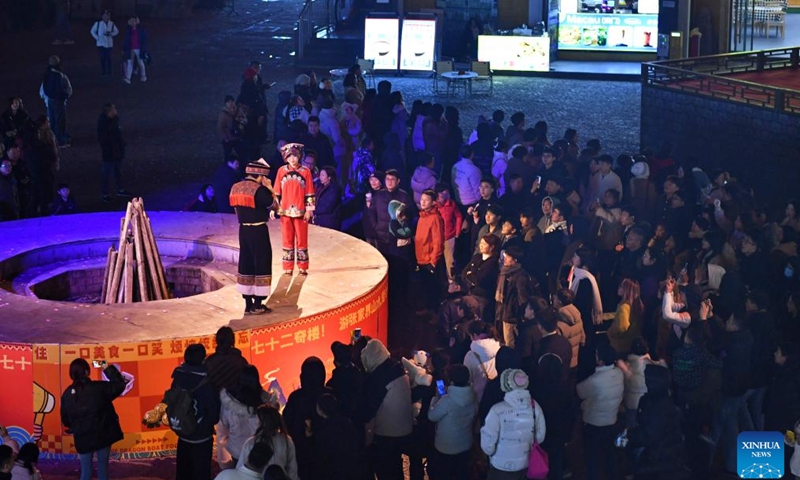 Tourists watch stage performance at a scenic spot noted for its splendid building in Zhangjiajie, central China's Hunan Province, on Jan. 9, 2025.