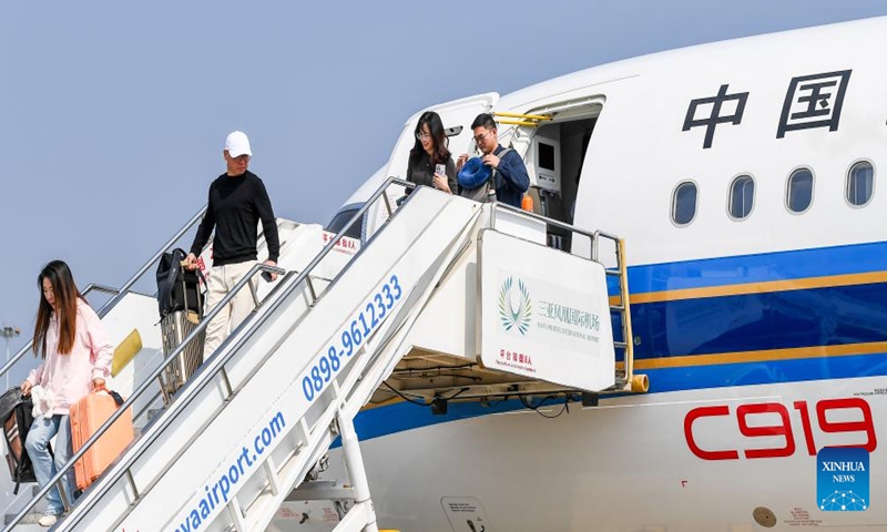 Passengers walk down from a C919 jetliner at Sanya Phoenix International Airport in Sanya, south China's Hainan Province, Jan. 10, 2025.(Photo:Xinhua)