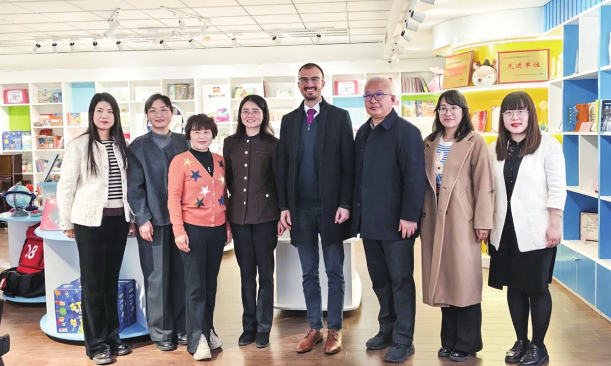 Arvind Norris, Trade and Investment Consul General and British Consul General Wuhan (center), and staff members pose for a group photo at Haiyan Publishing House, a professional children's publishing house in Henan Province. Photo: Henan Foreign Affairs WeChat official account