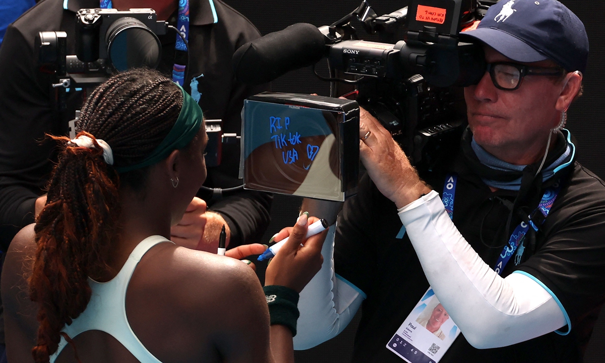 US tennis star Coco Gauff writes the message RIP TikTok USA on the camera following her victory over Switzerland's Belinda Bencic in their women's singles match at the Australian Open in Melbourne on January 19, 2025. Photo: VCG
