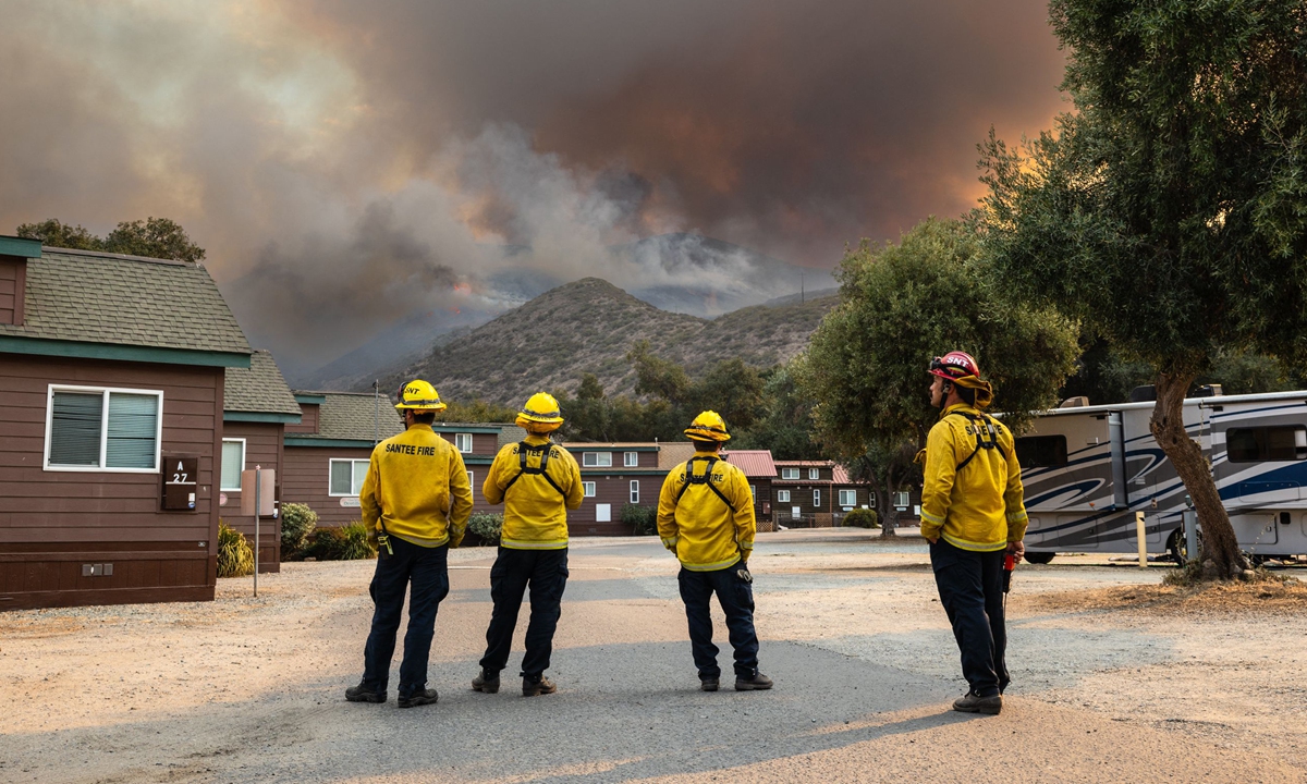 Firefighters watch as the Border Fire burns in the Otay Mountain Wilderness above Pio Pico Campground in Jamul, San Diego County, California, on January 24, 2025. Evacuation orders and warnings have been issued for areas to the fire's north, east and west, local media reported. Photo: VCG