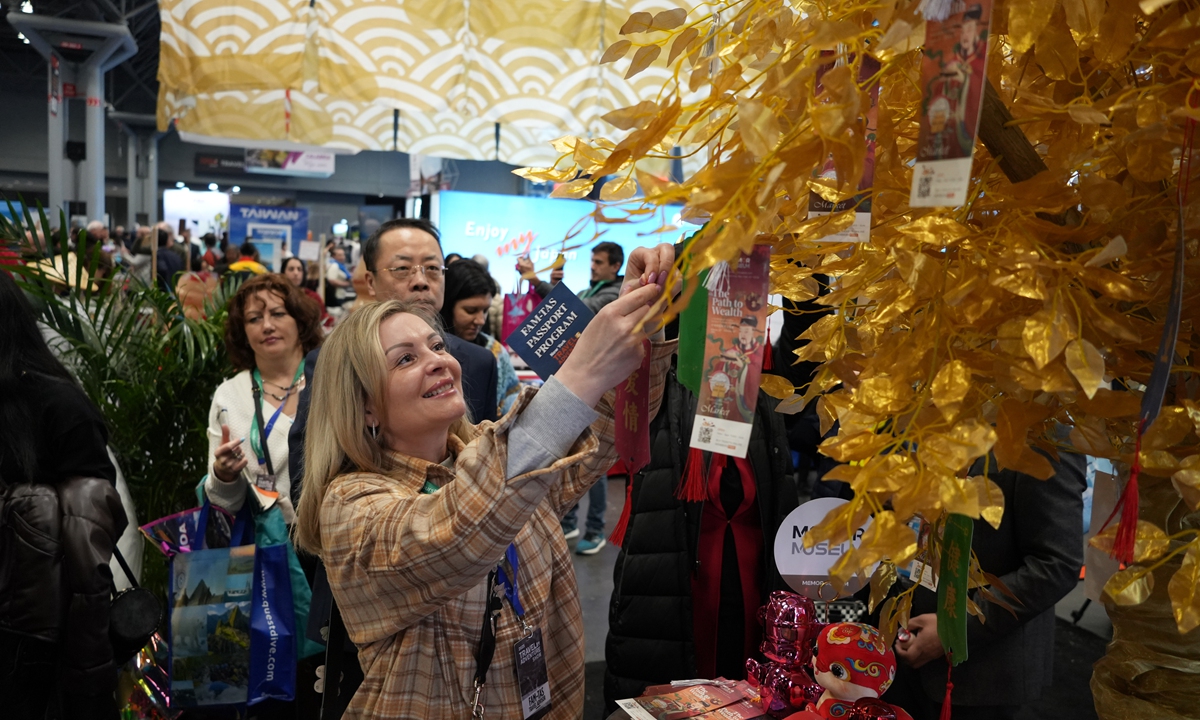 Visitors experience a wish-tree blessing at the 