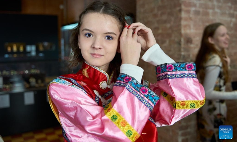 A participant tries on traditional Chinese costume during an event in celebration of the Chinese New Year at the Confucius Institute of Far Eastern Federal University of Russia, in Vladivostok, Russia, Jan. 29, 2025. The Confucius Institute of Far Eastern Federal University of Russia hosted a Chinese New Year cultural experience event, attracting many participants. Photo: Xinhua