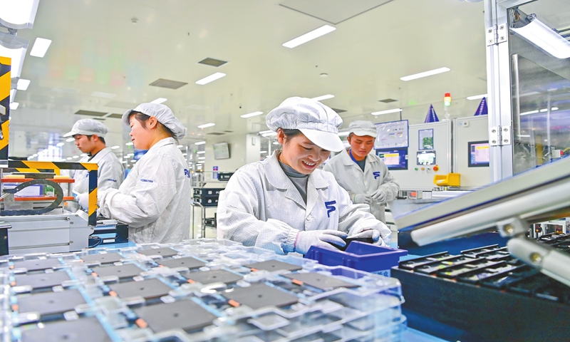 Workers assemble electronic products for new-energy vehicles in an intelligent workshop at a factory in the high-tech industrial park in Fengcheng, East China's Jiangxi Province on February 6, 2025. Local tech firms have been adopting new technologies such as cloud computing and artificial intelligence to empower their manufacturing capacity and elevate their product quality. Photo: VCG
