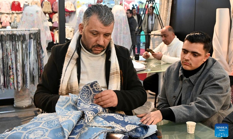 People attend the Khan al-Harir Exhibition for clothing, textiles, and weaving machinery in Damascus, Syria, on Feb. 6, 2025. (Photo by Ammar Safarjalani/Xinhua)