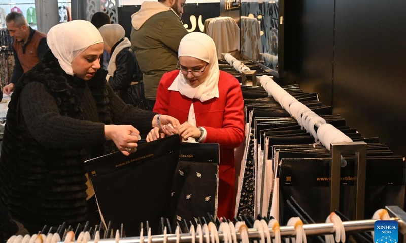 People attend the Khan al-Harir Exhibition for clothing, textiles, and weaving machinery in Damascus, Syria, on Feb. 6, 2025. (Photo by Ammar Safarjalani/Xinhua)