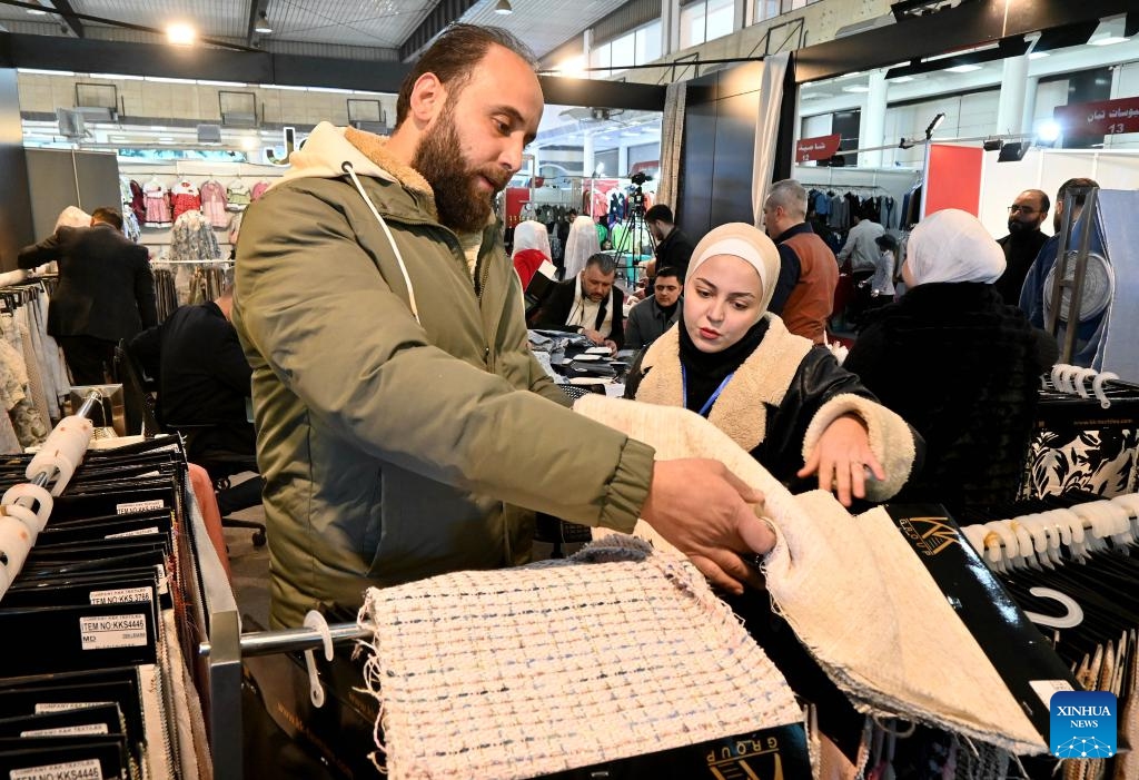 People attend the Khan al-Harir Exhibition for clothing, textiles, and weaving machinery in Damascus, Syria, on Feb. 6, 2025. (Photo by Ammar Safarjalani/Xinhua)