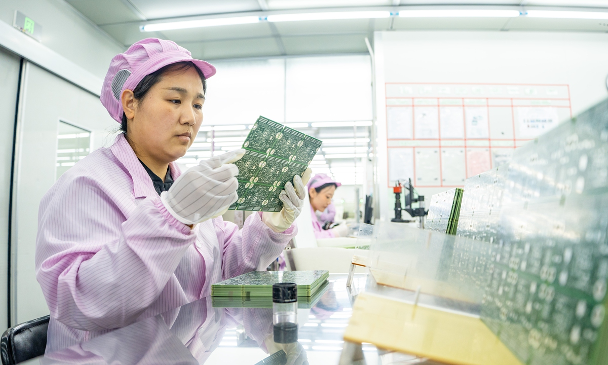 A worker inspects integrated circuits at an electronics company in Nantong, East China's Jiangsu Province on February 10, 2025 as the company catches up with strong demand overseas. Companies across China are resuming production following the Spring Festival holidays, and Jiangsu Province is aiming to grow its economy by more than 5 percent in 2025, according to CCTV. Photo: VCG