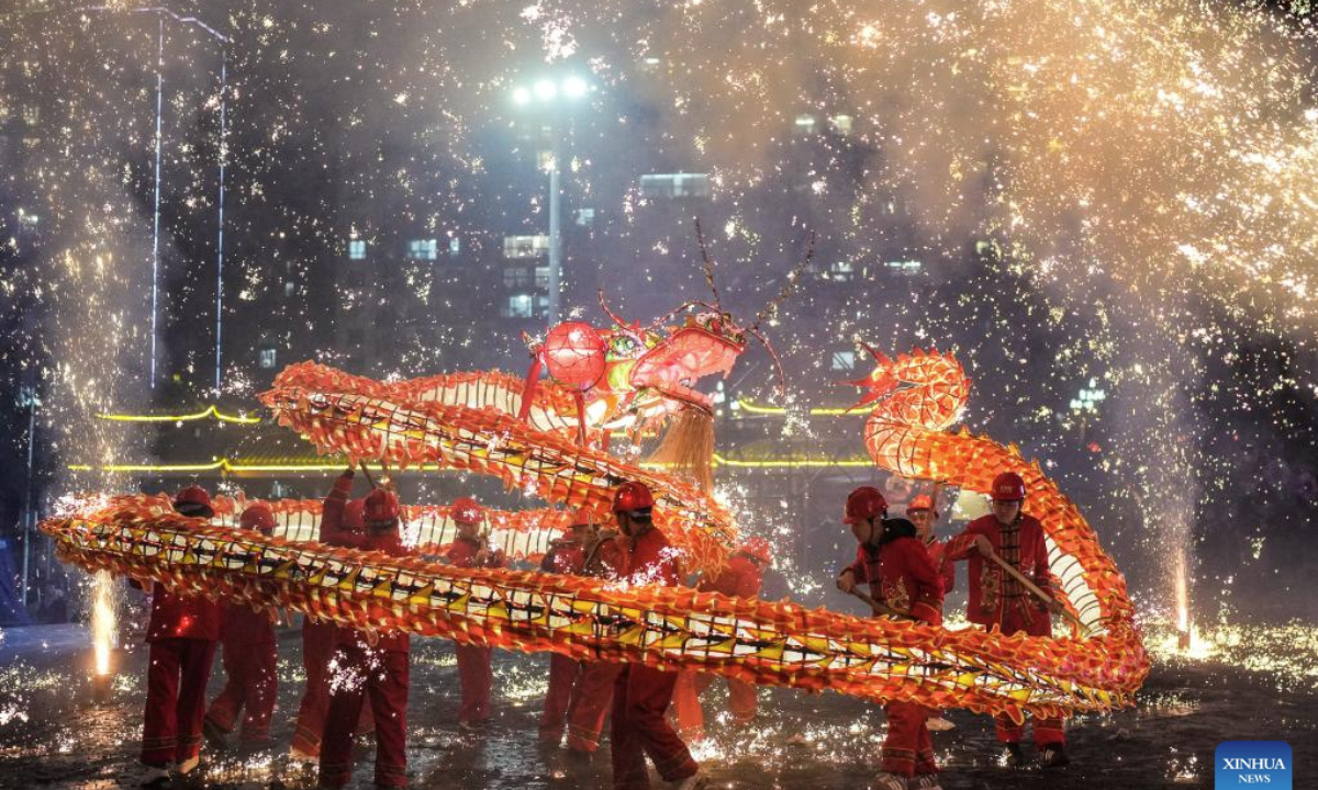 People attend a Wulong Xuhua show to celebrate the Lantern Festival in Taijiang County, southwest China's Guizhou Province, Feb. 11, 2025. The traditional Wulong Xuhua show is a genre of dragon dance performed amid fireworks by the Miao ethnic group. Wulong means the dragon dance, while Xuhua refers to a local specialty firework. Over 100 dragon dance teams gathered here to celebrate the Lantern Festival, the 15th day of the first month of the Chinese lunar calendar, which falls on Feb. 12 this year. (Xinhua/Tao Liang)