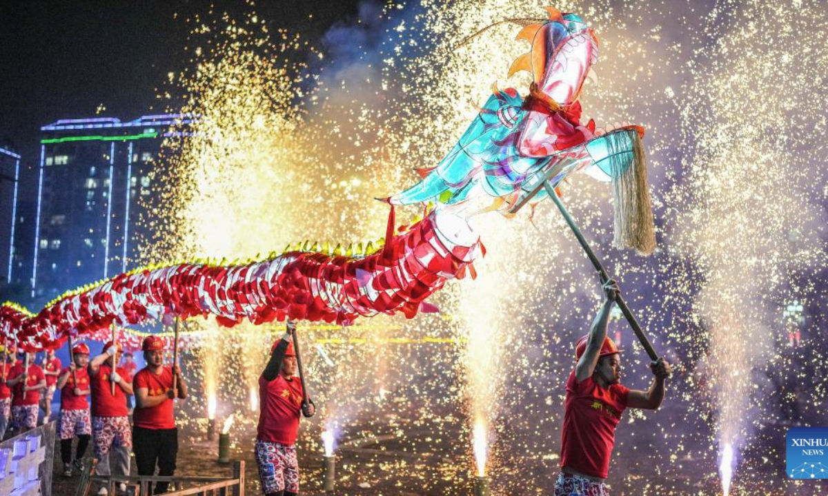 People attend a Wulong Xuhua show to celebrate the Lantern Festival in Taijiang County, southwest China's Guizhou Province, Feb. 11, 2025. The traditional Wulong Xuhua show is a genre of dragon dance performed amid fireworks by the Miao ethnic group. Wulong means the dragon dance, while Xuhua refers to a local specialty firework. Over 100 dragon dance teams gathered here to celebrate the Lantern Festival, the 15th day of the first month of the Chinese lunar calendar, which falls on Feb. 12 this year. (Xinhua/Tao Liang)