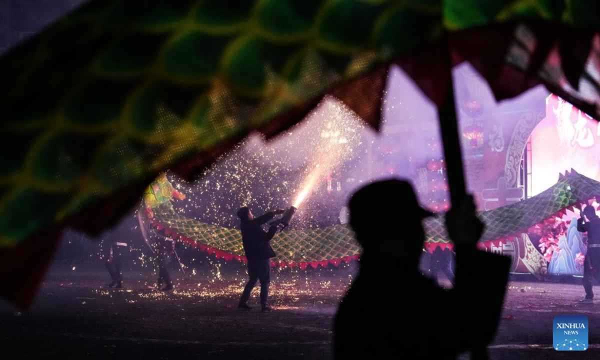 People attend a Wulong Xuhua show to celebrate the Lantern Festival in Taijiang County, southwest China's Guizhou Province, Feb. 11, 2025. The traditional Wulong Xuhua show is a genre of dragon dance performed amid fireworks by the Miao ethnic group. Wulong means the dragon dance, while Xuhua refers to a local specialty firework. Over 100 dragon dance teams gathered here to celebrate the Lantern Festival, the 15th day of the first month of the Chinese lunar calendar, which falls on Feb. 12 this year. (Xinhua/Tao Liang)