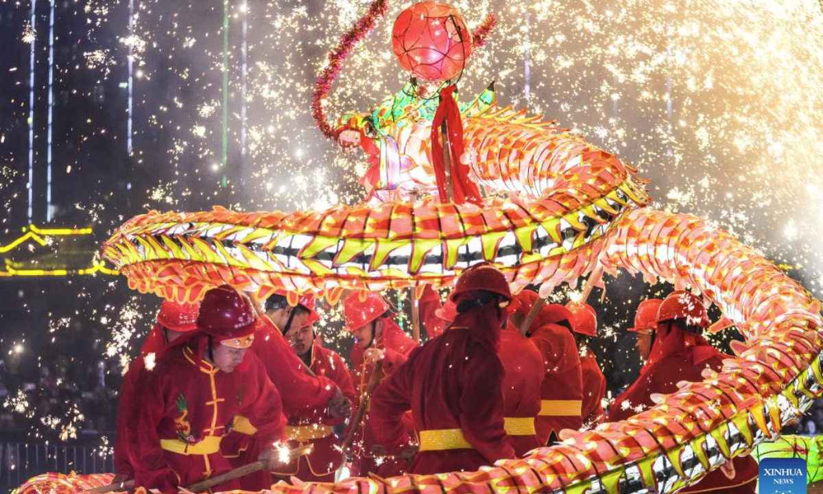People attend a Wulong Xuhua show to celebrate the Lantern Festival in Taijiang County, southwest China's Guizhou Province, Feb. 11, 2025. The traditional Wulong Xuhua show is a genre of dragon dance performed amid fireworks by the Miao ethnic group. Wulong means the dragon dance, while Xuhua refers to a local specialty firework. Over 100 dragon dance teams gathered here to celebrate the Lantern Festival, the 15th day of the first month of the Chinese lunar calendar, which falls on Feb. 12 this year. (Xinhua/Tao Liang)