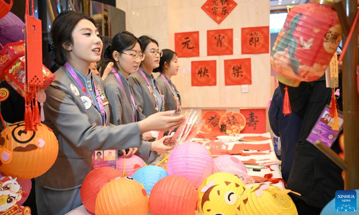 Staff members work at an activity to celebrate the Lantern Festival at press center for the 9th Asian Winter Games in Yabuli, northeast China's Heilongjiang Province, Feb. 12, 2025. (Xinhua/Hu Huhu)